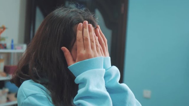 peek a boo. little girl covered her eyes face with her lifestyle hands hide - and - seek waiting for a surprise. slow motion video. teen girl playing bo-peep. childhood concept game hy - spy