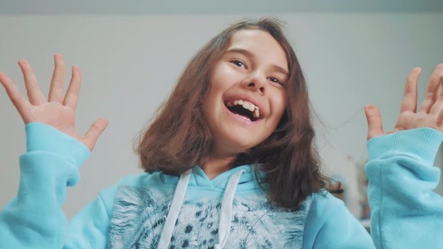 peek a boo. little girl covered her lifestyle eyes face with her hands hide - and - seek waiting for a surprise. slow motion video. teen girl playing bo-peep. childhood concept game hy - spy