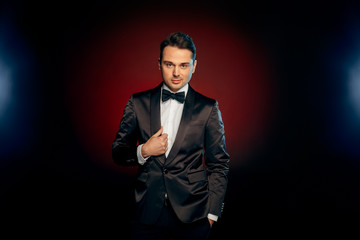 Obraz premium Professional Occupation. Showman in suit standing isolated on wall posing to camera playful