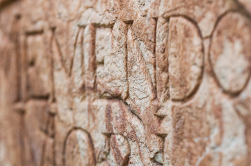 religious engraved letters on stone wall