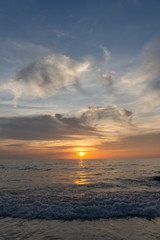 Naklejka na ściany i meble Colorful ocean beach sunset with a few clouds
