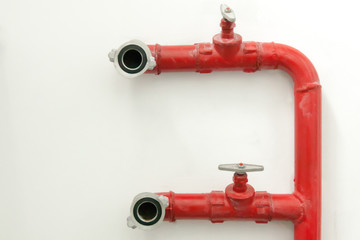 Water pipes for extinguishing fires against the background of a light wall inside the building. Fire protection system. Water supply.