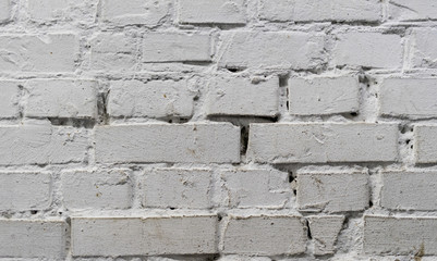 Tiled old painted white brick wall background in Kyiv, Ukraine
