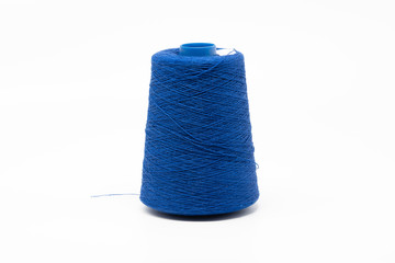 Blue textile yarn thread, isolated on white background.