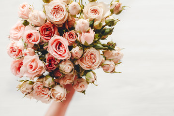 Pink small roses bouquet on white background isolated.  Top view with space for text. Floral...
