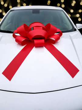 Bright Red Christmas Bow On New White Car Hood