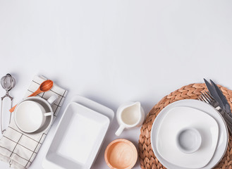 Different tableware and dishes on the white background, top view.