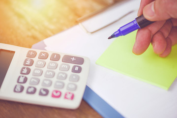 calculator and pen finance object business accounting concept / financial data analyzing hand...