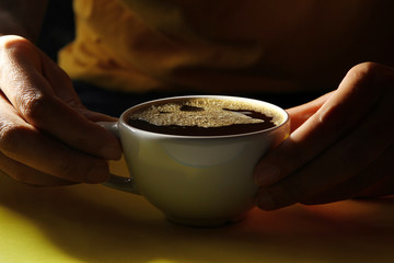 Hot coffee on yellow background