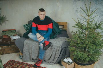 Portrait of cheerful male sitting on sofa,  man resting