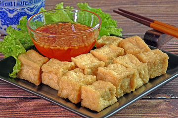 Tofu. Traditional fried Tofu , served with sweet chili sauce or sweet plum sauce. Famous Chinese appitizer / Chinese cuisine. Vegetarian food.