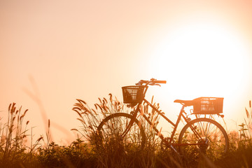 beautiful landscape image with Bicycle at sunset
