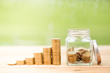 Close up of stacking money coins and home model, the saving with growing your money to real estate...