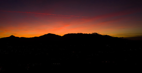 Aerial view of a spectacular sunset behind some beautiful mountains in Italy.