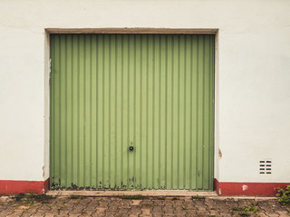 old, washed-out green garage door