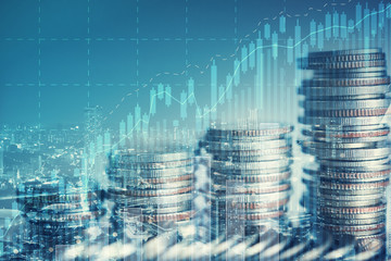 Double exposure of city and rows of coins with business graph for finance and banking concept