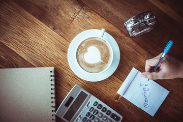 cup of Coffee latte art Heart shape with office tools on table