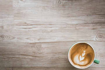 Cup of coffee Latte art  on wooden table, top view,a cup of green pastel.with copy space.