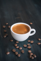 Obraz na płótnie Canvas Fresh tasty espresso cup of hot coffee with coffee beans on dark background