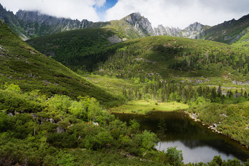 Fototapeta na wymiar Mountains under the name Dusse Alin in Russian Far East Khabarovsk region. Beautiful Mountain Lake is called the Sealin the mountains Dusse Alin.