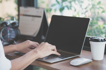 woman using laptop, searching web, browsing information, having workplace at coffee shop.