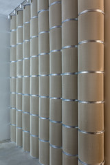 Beige textured columns with metal chrome rings
