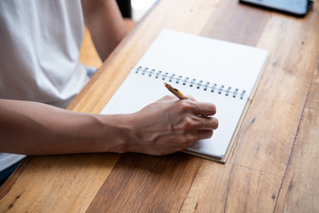 Closeup of man's hand writing on paper
