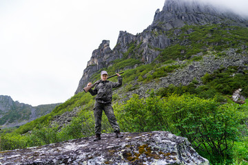 Travelers in the mountains Duse Alin Russian Far East Khabarovsk region. Girl with gun on mountain...