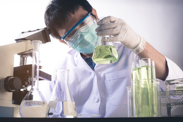scientist with equipment and science experiments ,Laboratory glassware containing chemical liquid,...