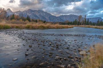 Cloudy skies and mountains in fall at sunrise
