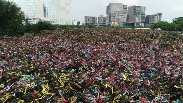 Slow drone flight over abandoned rental bicycles at a garbage dump in Shanghai, failure of shared bike program in China