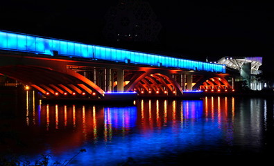Fototapeta na wymiar Evening View of the Love River and Illuminated Bridge