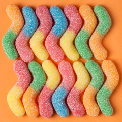 Fruit gummy candy on yellow background. Jelly Bean
