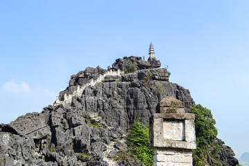 Hang Mua Mountain viewpoint or Mua Caves Ecolodge, Stunning view of Tam Coc area with mountain range, rice fields and waterway.