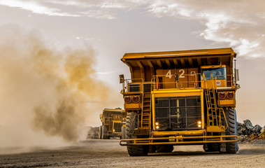 Mining dump trucks transporting Platinum ore for processing