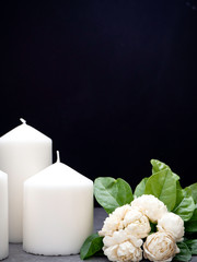 Jasmine and candles on dark background
