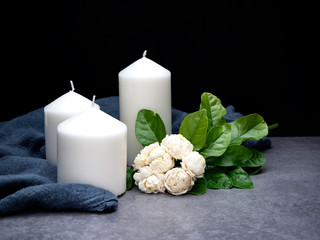 Jasmine and candles on dark background