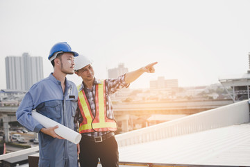 Engineer and architect are planning or consulting the construction of new projects, Blueprint for...