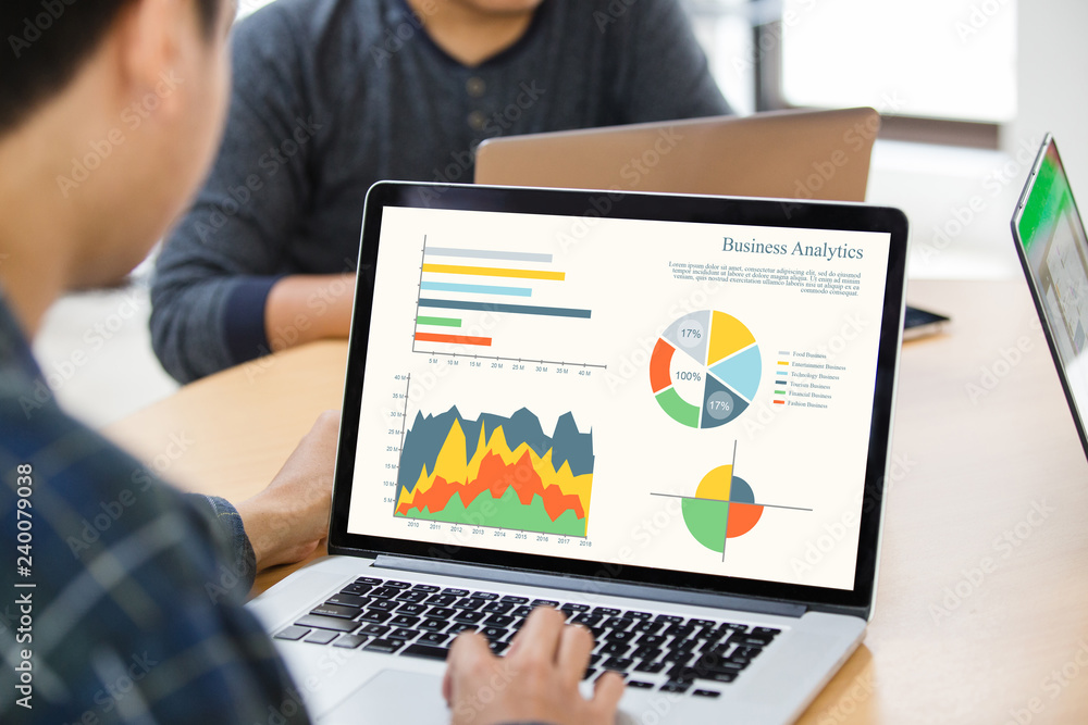 Poster back view of businessman using laptop analyzing statistics data on laptop screen, working with graph