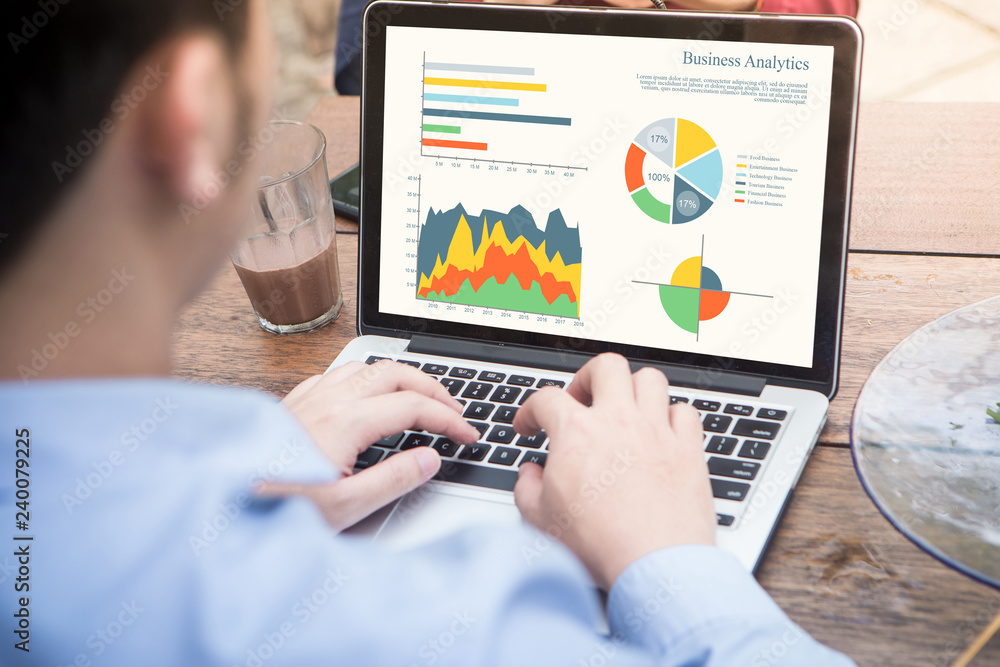 Poster back view of businessman using laptop analyzing statistics data on laptop screen, working with graph