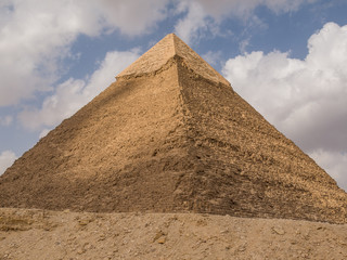 Fototapeta na wymiar Great pyramid in Cairo Egypt on a sunny day with blue sky and white clouds