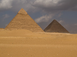 Fototapeta na wymiar Two of the great pyramids with one in the sun and one in shadow