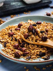 Homemade granola with honey and chestnuts on blue