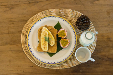 breakfast with milk and peanut butter banana toast and passion fruit