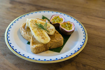peanut butter banana toast and fruit rosemary on a plate