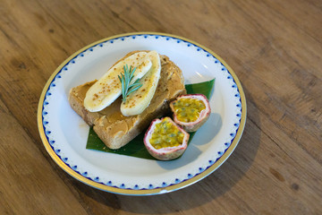peanut butter banana toast and fruit rosemary on a plate