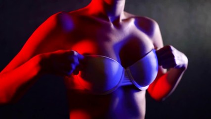 close up. large natural Breasts in a white bra. the girl hands up and down his chest to demonstrate