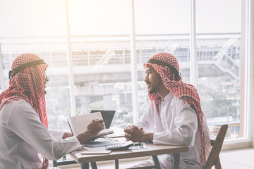 Two Arab business people working together in an office business project.