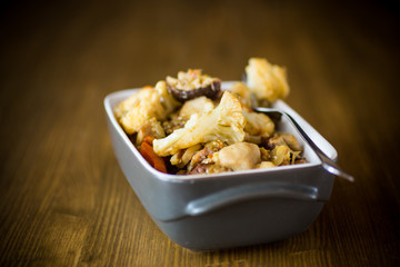 Cauliflower baked with mushrooms and eggplants in ceramic form