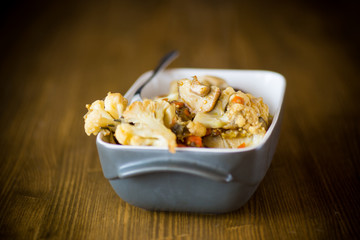 Cauliflower baked with mushrooms and eggplants in ceramic form